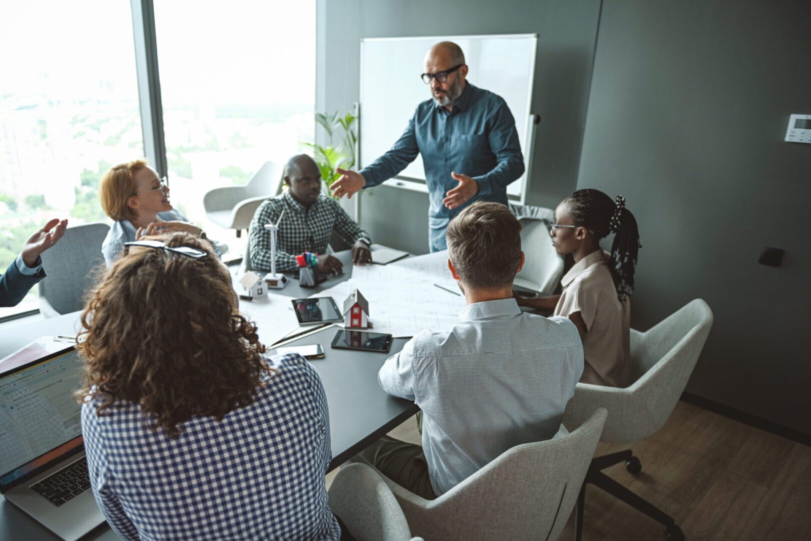 A group meeting in a modern office around a conference table.