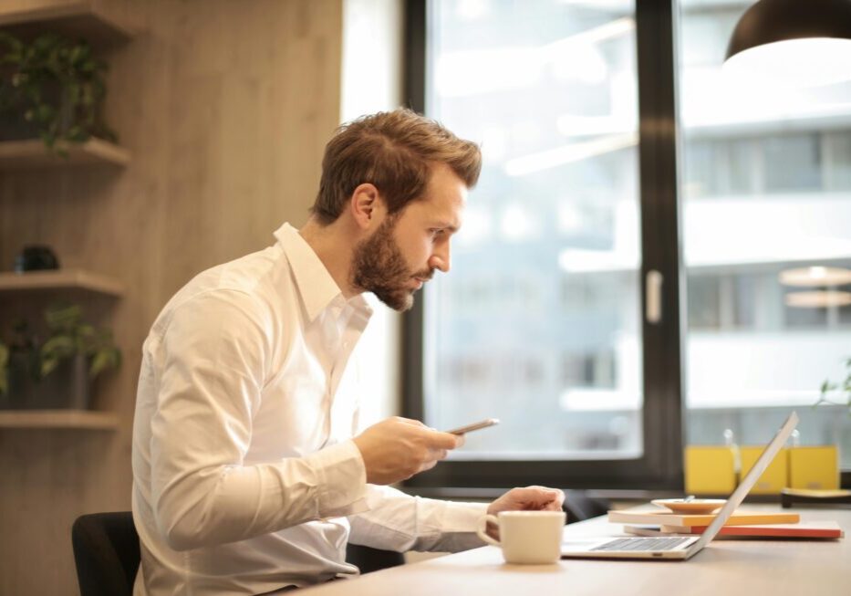 Man working on laptop in office.