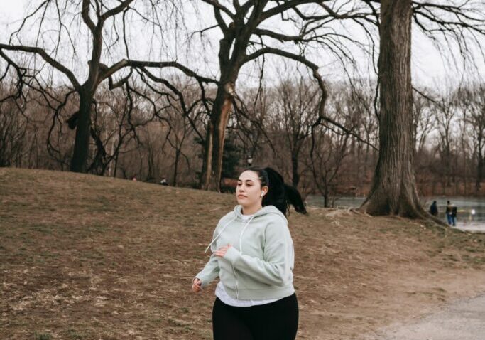Person jogging in a park during winter.