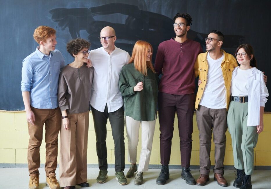 Group of people smiling in casual attire.