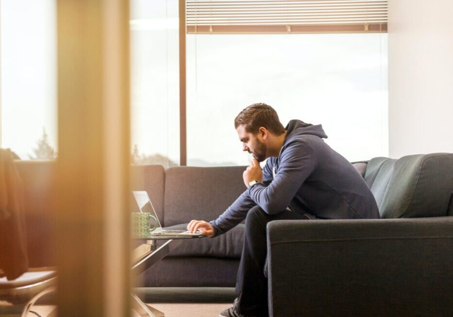 Man working on laptop in modern office.