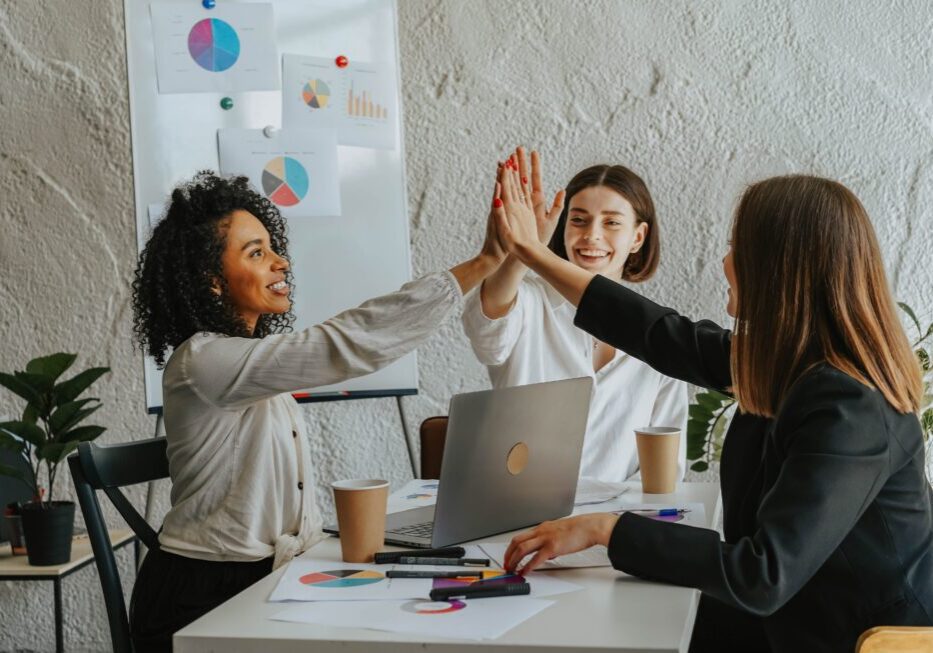 Team celebrating success with a high-five.