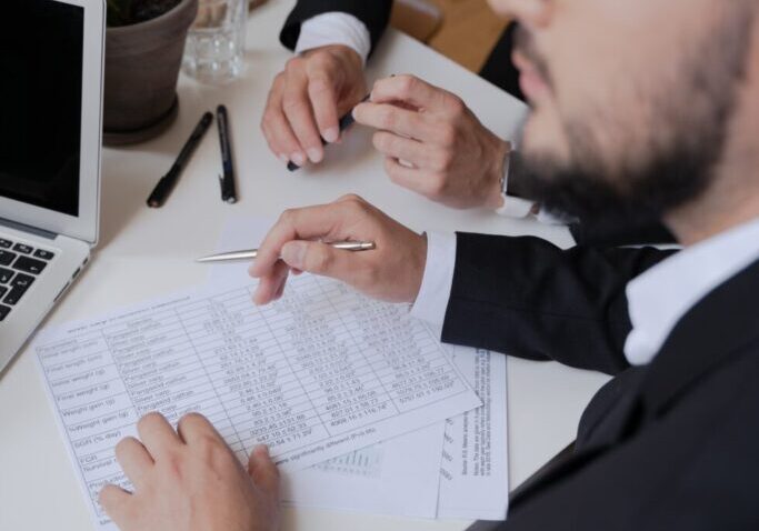 Business meeting with documents and laptop.